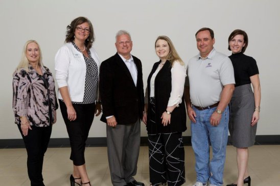 Carolyn Motl, retired Entergy Texas community developer (left) and Melissa Bochat, Entergy Texas community development program rep. (right) with scholarship recipients (from left) Shannan Reid, Johnny McNally, Heather Neeley and Courtland Holman. 